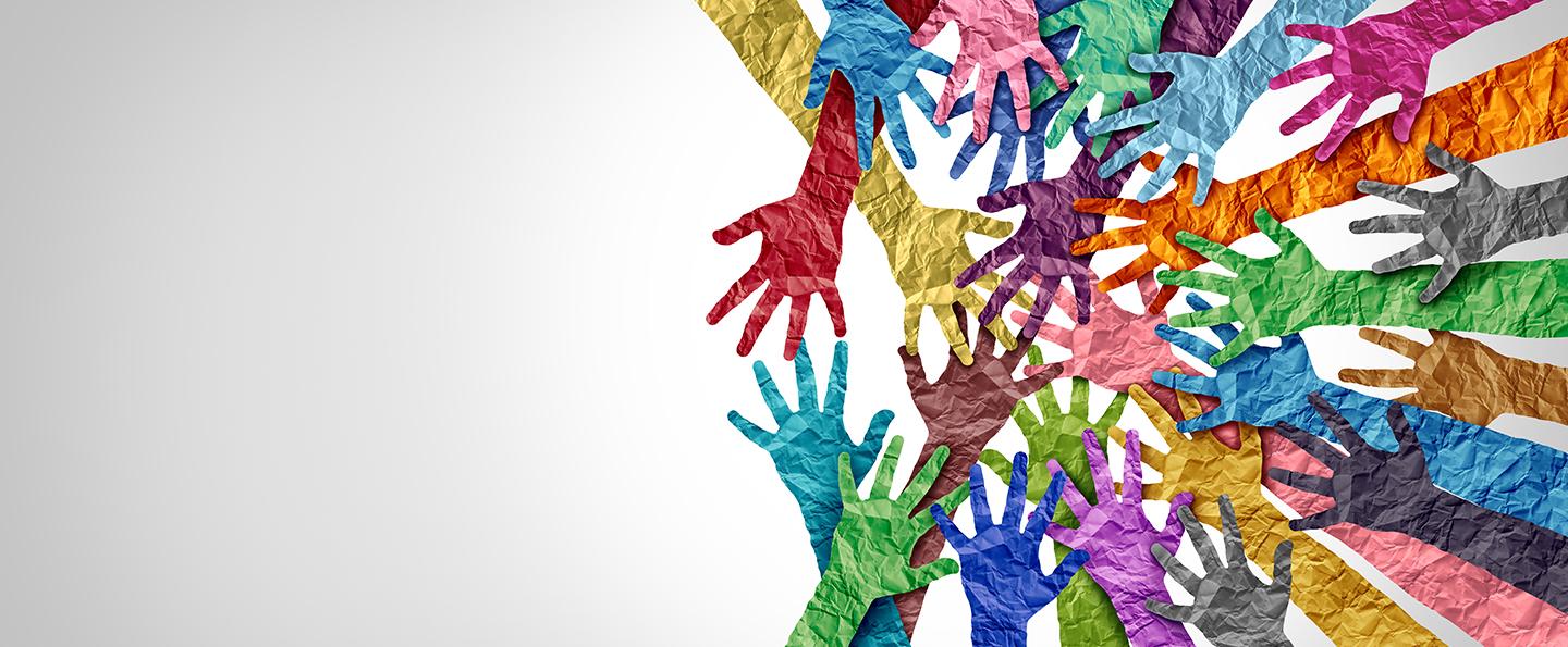 Full spectrum of colored paper hands reaching toward a point on the right side of the image, suggesting a common goal
