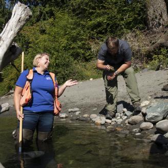U.S. Department of Agriculture (USDA) Natural Resources Conservation Service (NRCS) Biologist Rachel Maggi and Resource Conservationist (Mount Vernon Field Office) Jared Hamman inspect a sample of aquatic insects as measure of habitat recovery near an engineered log jam structure in the Nooksack River, Washington, on August 7, 2019.
NRCS in Washington State works with Tribes and other salmon recovery partners to restore salmon habitat in the South Fork Nooksack River (Whatcom County, WA). NRCS has contrib