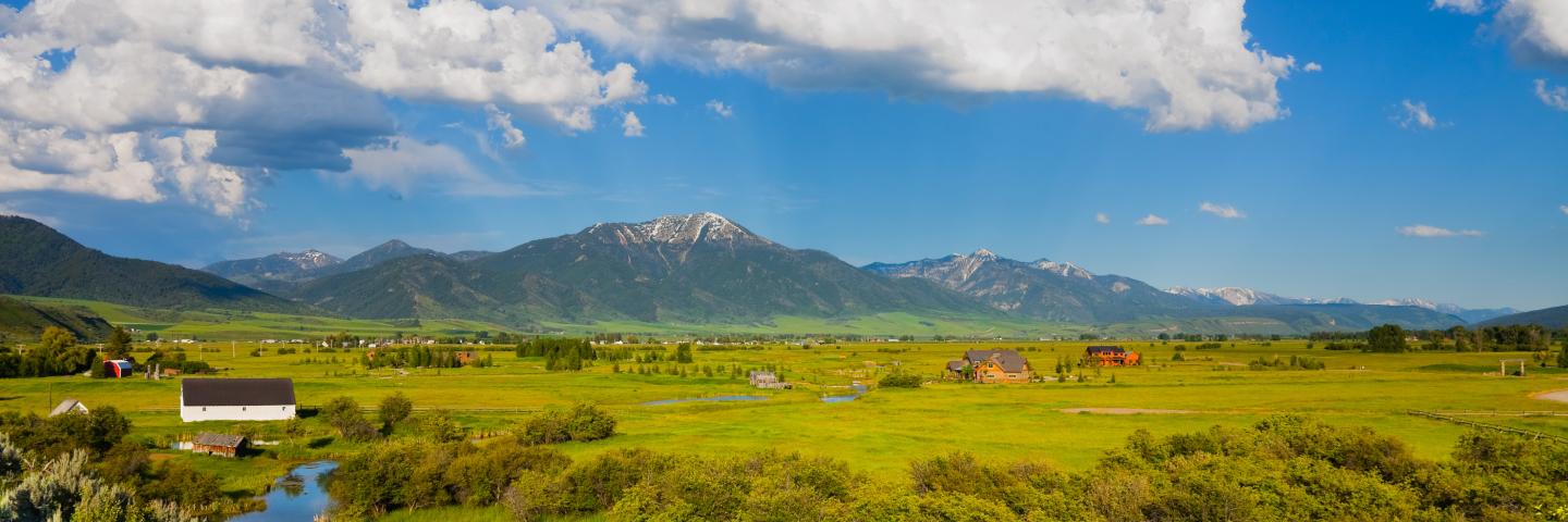 mountain and farmstead with a blue sky