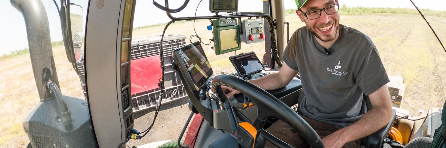 Alexander Frick, Jr. in his tractor/planter planting soybean seeds with the aid of precision agriculture systems and information, Alexander Frick, Jr., a.k.a. Alē, and his father Alexander Frick, Sr. are co-owners of Frick Farms, LLC, where they farm non-irrigated corn, soybeans, and wheat on more than 3,000 acres in northeast Texas, on April 13, 2021. In 2017 they began incorporating precision agriculture technology into their farming operation.. Their conservation practices include precision agriculture,