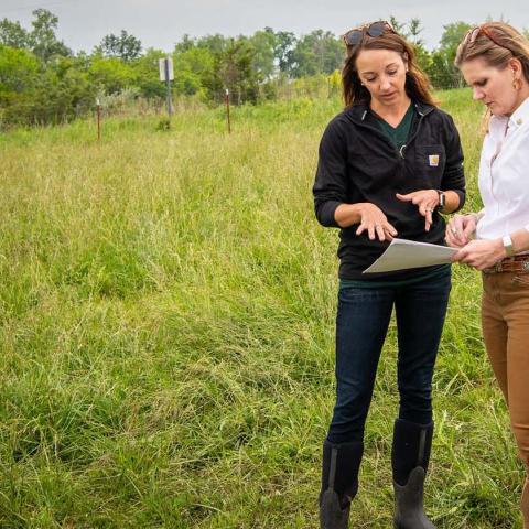 Mandi Bird showing NRCS Chief Bettencourt rotational grazing plans papers