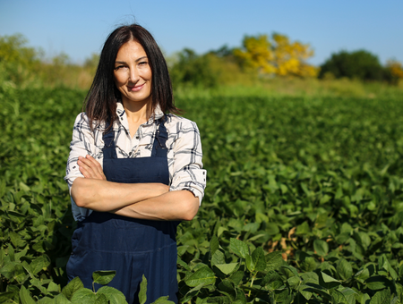 woman farmer standing in soybean field