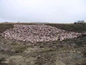 A newly constructed rock chute grade stabilization structure on a grassed waterway.