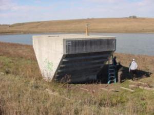 The concrete inlet riser for a principal spillway pipe on a watershed dam.