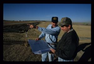 A NRCS engineer working with a contractor at a construction site.